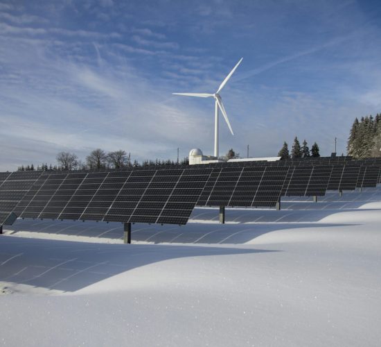 pexels-photo-433308-433308 Solar panels and wind turbine in a snowy landscape, showcasing renewable energy sources.