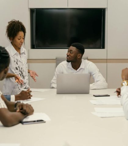 A diverse team of professionals collaborating in a modern office meeting environment.